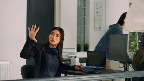 IT engineer using computer and turning head to use source code hologram Stockfoto's