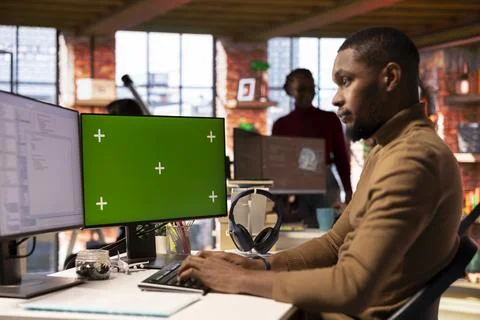 IT engineer using green screen PC in startup office and programming languages 库存照片