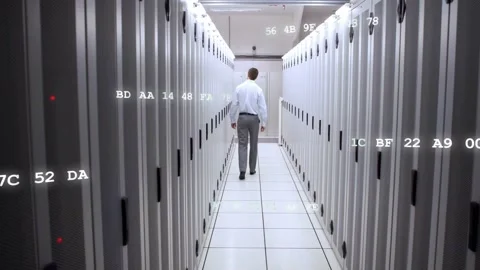 IT engineer walking data center aisle after alert, inspecting and monitoring hex Stock Footage 332704746