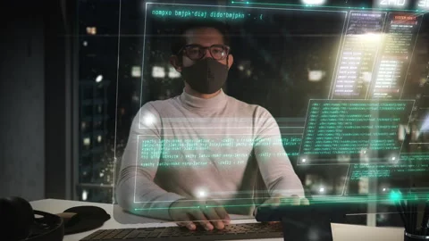IT Engineer Wearing Protective Face Mask Working on Modern Office At Night. Video stock 137861889