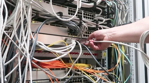 IT engineer working in a data center. Hand inserts the cable Stock Footage 90000134