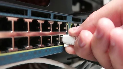 IT engineer working in a data center. Сhecking the network cable RG45. Stock Footage 90000259