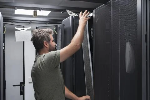 IT engineer working In the server room or data center The technician puts in a Stock Photos