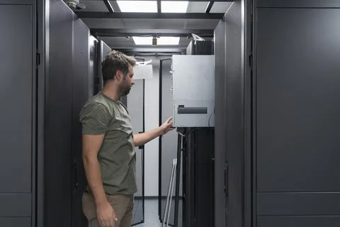 IT engineer working In the server room or data center The technician puts in a Stock Photos