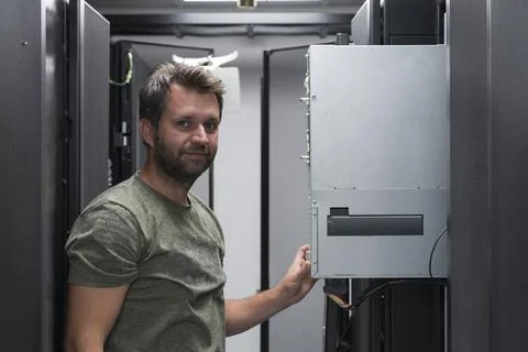 IT engineer working In the server room or data center The technician puts in a Stock Photos