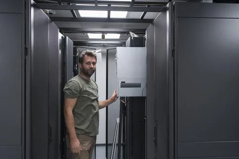 IT engineer working In the server room or data center The technician puts in a Stock Photos