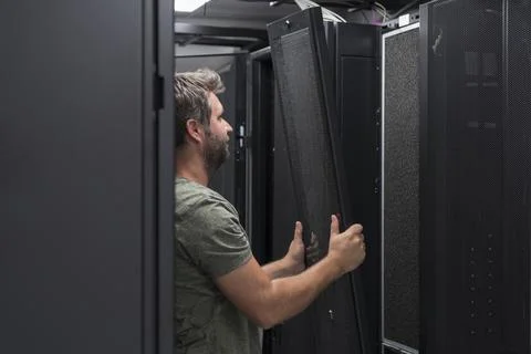 IT engineer working In the server room or data center The technician puts in a Stock Photos