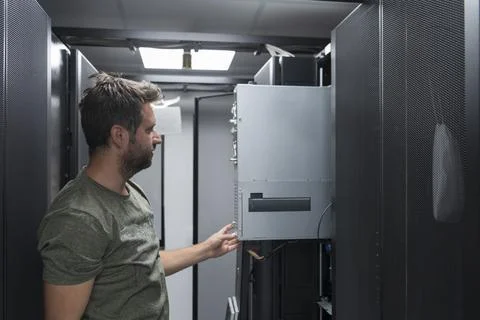 IT engineer working In the server room or data center The technician puts in a Stock Photos
