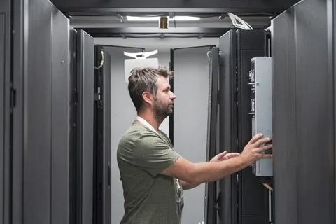 IT engineer working In the server room or data center The technician puts in a Stock Photos