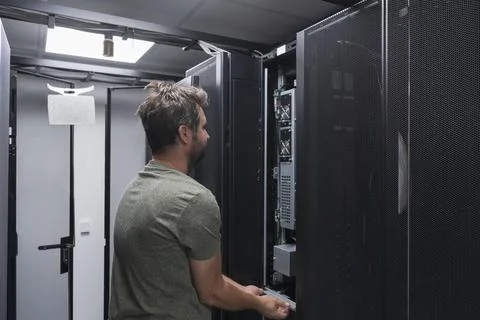 IT engineer working In the server room or data center The technician puts in a Stock Photos