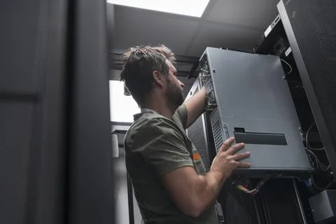 IT engineer working In the server room or data center The technician puts in a Stock Photos