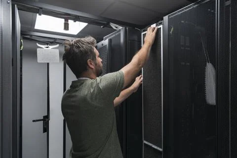 IT engineer working In the server room or data center The technician puts in a Stock Photos