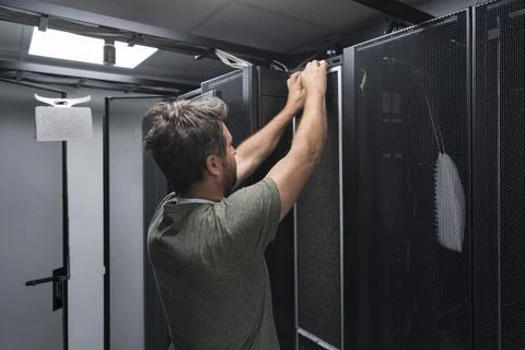 IT engineer working In the server room or data center The technician puts in a Stock Photos