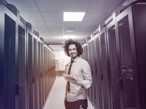 IT engineer working on a tablet computer in server room Male IT engineer w... Stock-Fotos