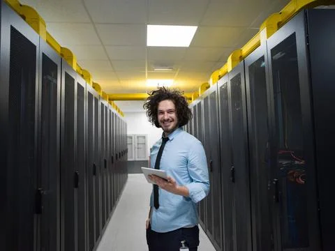 IT engineer working on a tablet computer in server room Male IT engineer w... Stock-Fotos