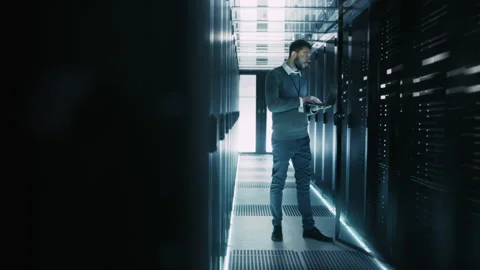 IT Engineer Works on Laptop in Data Center Stock Footage 320999549