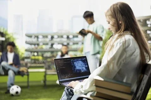 IT engineering student working on laptop with AI binary code Stock Photos