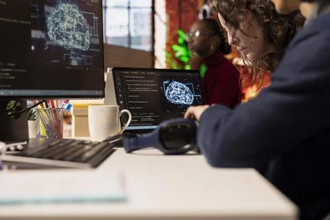IT engineers cooperating in AI focused startup, close up Stock Photos