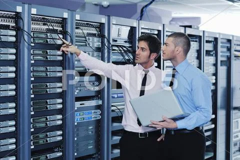 It engineers in network server room Stock Photos