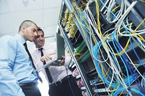 It engineers in network server room Stock Photos