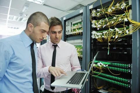 It engineers in network server room Stock Photos