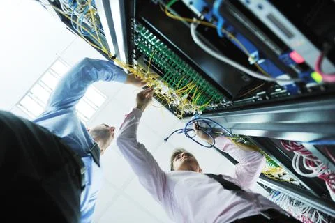 It engineers in network server room Stock Photos