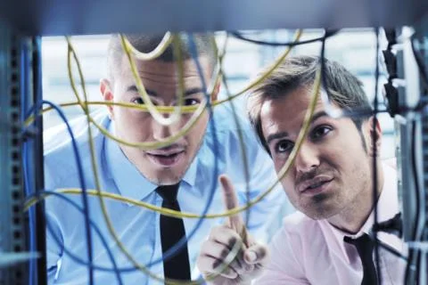 It engineers in network server room Stock Photos