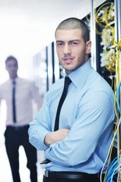 It engineers in network server room Stock Photos
