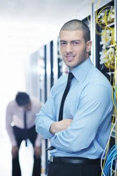 It engineers in network server room Stock Photos