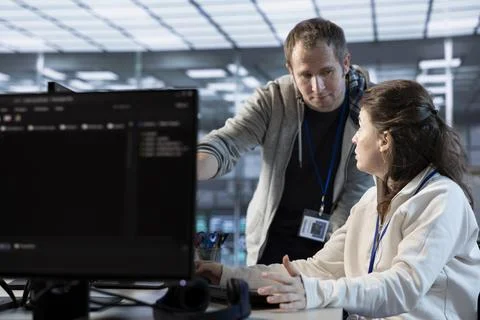 IT engineers in server farm brainstorming ways to repair equipment Stock Photos