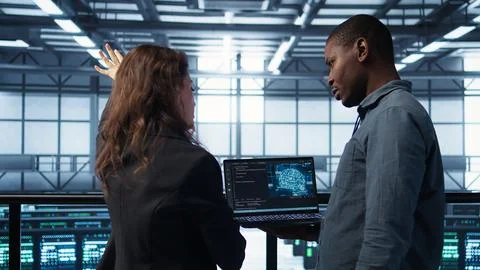 IT expert coding on notebook in server room using artificial intelligence 写真素材