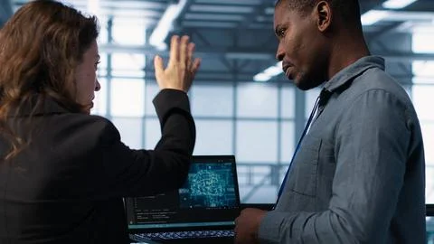 IT expert coding on notebook in server room using artificial intelligence 스톡 사진