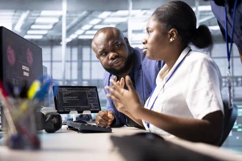 IT expert in data center facility requesting assistance to fix security breach Stock Photos