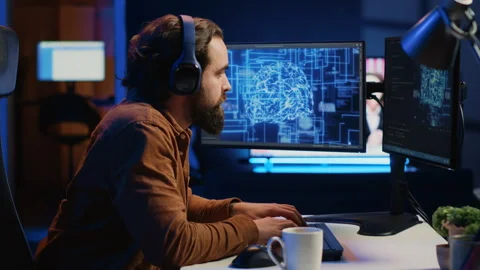 IT expert enjoying coffee and audio podcasts while writing AI code Stock Footage 265621883