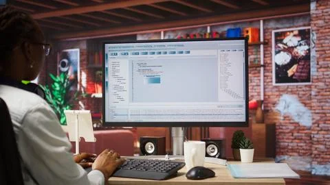 IT expert in home office working with code editor Stock Photos