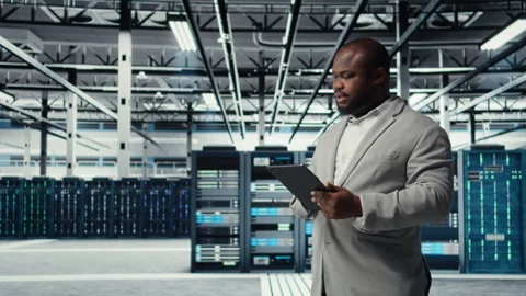 IT expert in industrial data center analyzing infrastructure performance 스톡 동영상 311961459