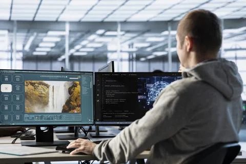 IT expert in office coding AI virtual assistant producing clips Stock Photos