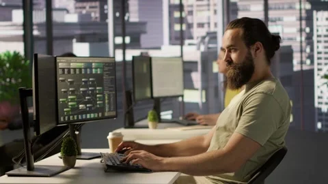 IT expert in office focused on transforming data into predictive models Stock Footage 318159778