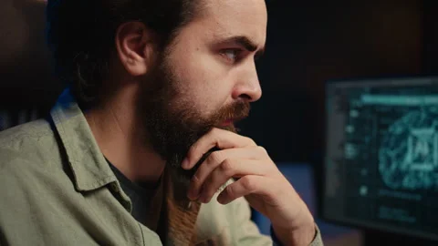 IT expert programming to upgrade AI brain, close up on face expressions Stock Footage 267045237