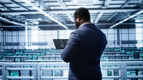 IT expert in server hub facility looking for network bugs with tablet Stock Footage 277645883