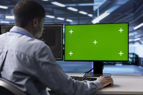 IT expert in server hub fixing errors slowing down hardware using chroma key PC 스톡 사진