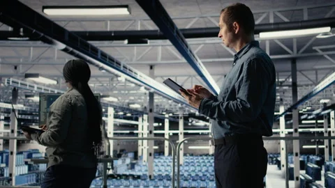 IT expert in server hub uses tablet to optimize deep learning AI systems Stock Footage 314805302