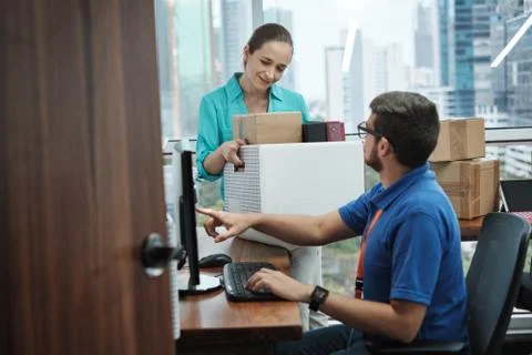 IT Expert Setting Computer To Woman Moving Into New Office Stock Photos