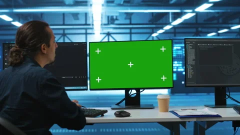 IT expert supervising data center supercomputers using mockup computer monitor Stock Footage 276194499