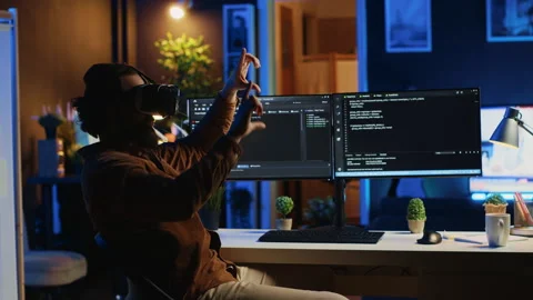 IT expert wearing high tech virtual reality headset to visualize lines of code Stock Footage 265513638