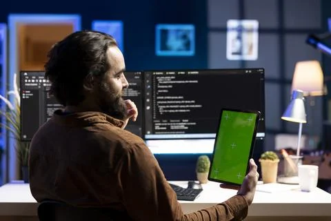 IT expert working on mockup tablet, preventing malware attacks Photos