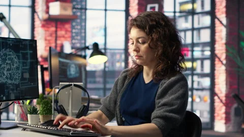 IT expert writing code and debugging on artificial intelligence neural networks Stock Footage 308603537