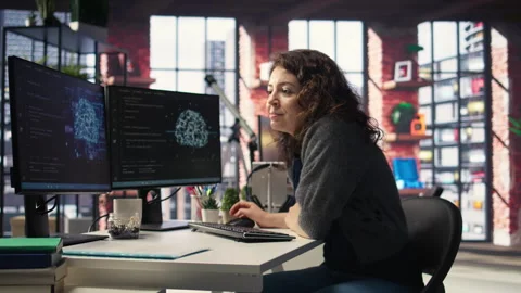 IT expert writing code and debugging on artificial intelligence neural networks Stock Footage 308673241