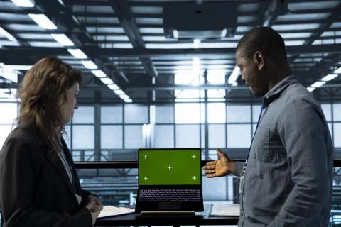 IT experts in server farm testing failover scenarios on chroma key device Stock Photos