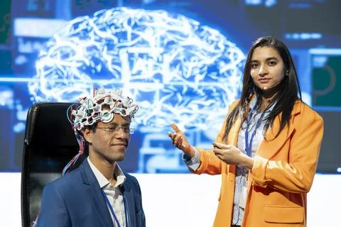 IT experts talking at AI summit, sharing neural implants product presentation Stock Photos
